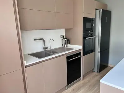a kitchen with a sink and a refrigerator at Central Istanbul, Luxury 3BR, 4 min to Metro in Istanbul