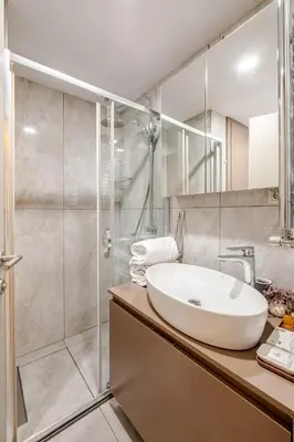 a bathroom with a sink and a shower at Central Istanbul, Luxury 3BR, 4 min to Metro in Istanbul