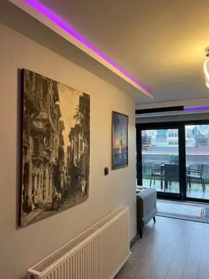 a living room with a painting on the wall at Ortakoy Suit in Istanbul