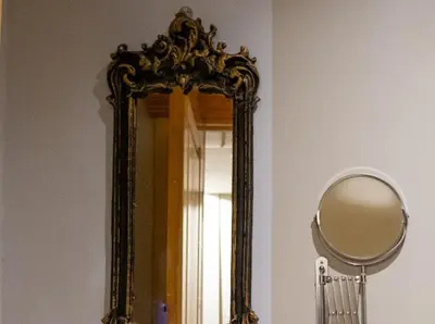 a mirror with a gold frame on a wall at Fatih Balat tarihin içinden konut - 3 in Istanbul