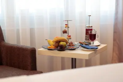 a table with a plate of fruit on it at Dedeman Istanbul in Istanbul