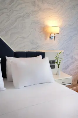 a bedroom with a white bed and a lamp at Dedeman Istanbul in Istanbul