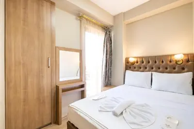 a bedroom with a large white bed with a window at Lavin Hotel & Suites in Istanbul
