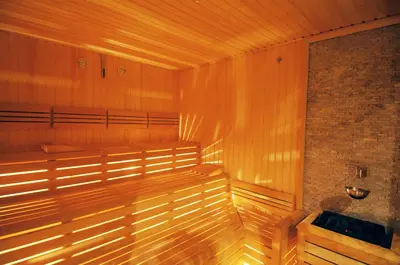 a sauna with a wooden bench in a room at Titanic Business Kartal in Istanbul