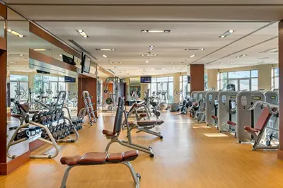a gym with a lot of treadmills and machines at Titanic Business Kartal in Istanbul