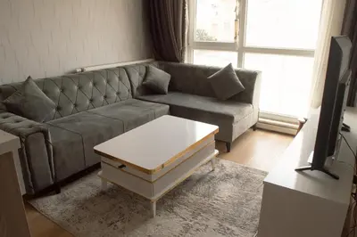 a living room with a couch and a coffee table at Classic Suite AA7 in Esenyurt