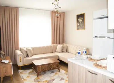 a living room with a couch and a table at Two Bedroom King Suite TH30 in Esenyurt