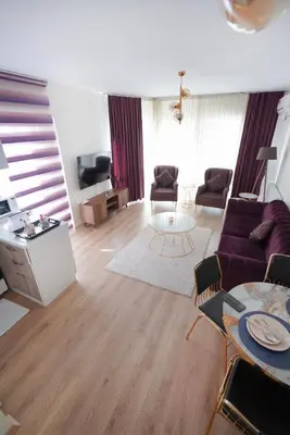 a living room with a couch and a table at King Suite SS2 in Esenyurt