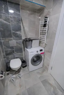 a bathroom with a washing machine and a toilet at King Suite SS2 in Esenyurt