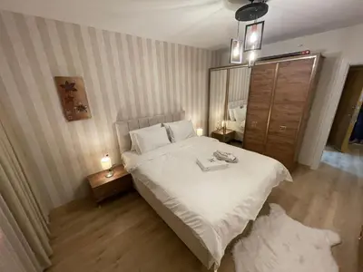a bedroom with a bed with a mirror and a dresser at King Suite MS5 in Esenyurt