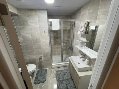 a bathroom with a shower and a toilet and a sink at King Suite TC1 in Esenyurt