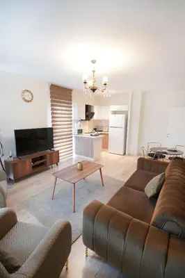 a living room with a couch and a table at King Suite AM2 in Esenyurt