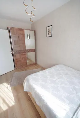 a bedroom with a white bed and a sliding door at Luxe Suite AI3 in Esenyurt