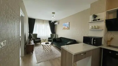 a living room with a green couch and a living room at Luxe Suite AI3 in Esenyurt