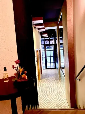 a hallway with a table and a door to a room at Mates Port Hotel in Istanbul