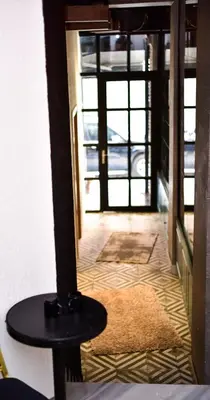 aoyer with a table in front of a door at Mates Port Hotel in Istanbul