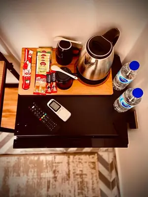 a counter top with a table with a pot and water at Mates Port Hotel in Istanbul