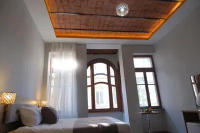 a bedroom with a bed and a ceiling with a window at Adamantides Hotel in Istanbul