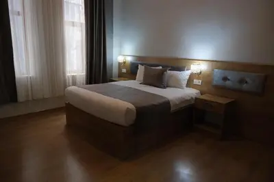 a bedroom with a large bed with two lamps on it at Adamantides Hotel in Istanbul