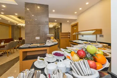a buffet line with plates of food in a restaurant at Bisetun Hotel in Istanbul