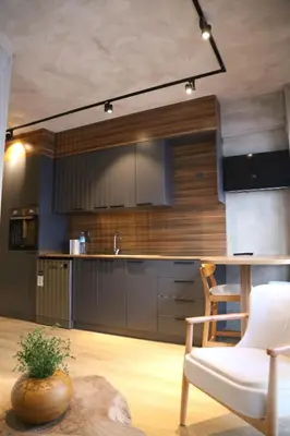 a kitchen with a white chair and a kitchen counter at BlokNoi in Istanbul