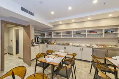 a kitchen and dining room with tables and chairs at Taximist Hotel in Istanbul