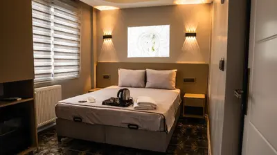 a bedroom with a bed with a tea kettle on it at CK Boutique Hotel in Istanbul