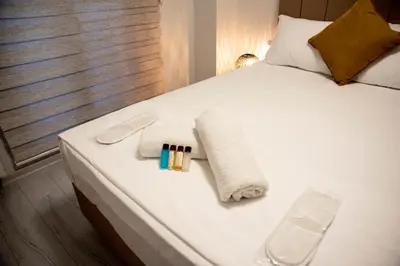 a bed with two towels and two candles on it at CK Boutique Hotel in Istanbul