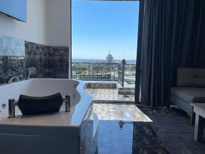 a bath tub in a room with a large window at CK Boutique Hotel in Istanbul