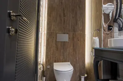 a bathroom with a toilet and a sink at SHERLOCK HOMES HOTELS in Istanbul