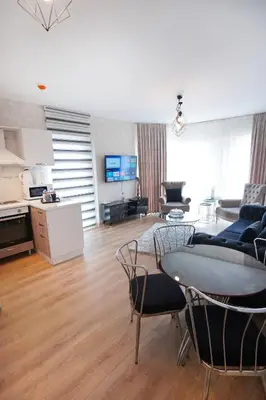 a living room with a table and chairs at King Suite AE8 in Esenyurt