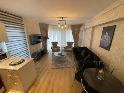 a living room with a couch and a table at King Suite AE8 in Esenyurt