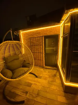 a wicker chair sitting on a balcony at night at Golden Arrow Hotel in Istanbul