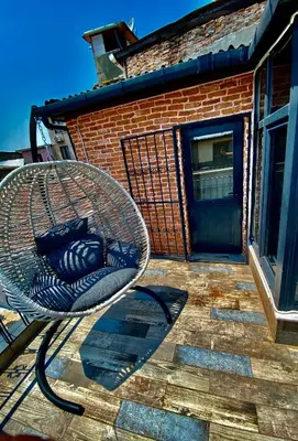 a wicker chair sitting on a patio in front of a building at Golden Arrow Hotel in Istanbul