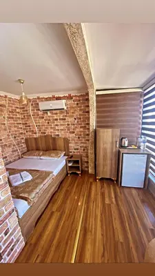 a bedroom with a bed and a brick wall at Golden Arrow Hotel in Istanbul