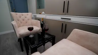 a room with two glasses of wine and a chair at AURA MARINA HOTEL in Istanbul