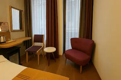 a hotel room with a bed and a chair and a table at Aleksandr Pera Hotel in Istanbul