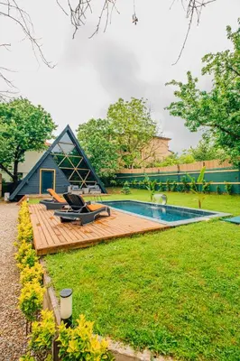 a tiny house with a pool and a deck at Dark Sapanca in Sapanca