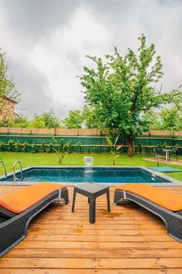 a swimming pool with a table and benches in a yard at Dark Sapanca in Sapanca