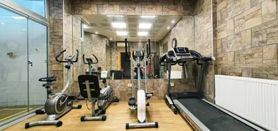 a gym with a bunch of exercise equipment in a room at Cihangir Flat in Istanbul