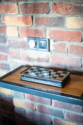 a chess board on a table in front of a brick wall at Mansion Gorki in Istanbul