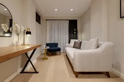 a living room with a white couch and a chair at Gleam Collection Hotel in Istanbul
