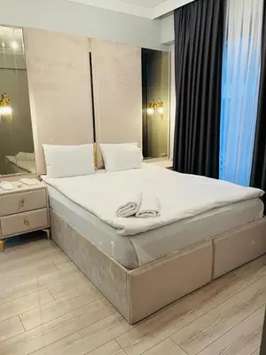 a large bed in a bedroom with a mirror at GANİGAR alibeyköy in Istanbul