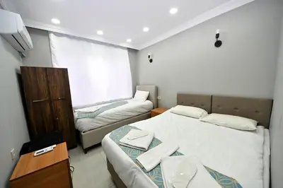 a small room with two beds and a couch at GRAND Deniz Hotel in Istanbul