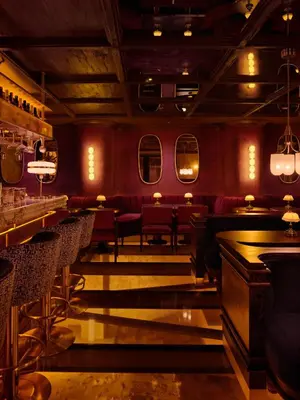 a restaurant with red walls and chairs and a bar at Shining Star Hotel in Istanbul