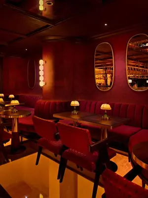 a restaurant with red booths and tables and mirrors at Shining Star Hotel in Istanbul