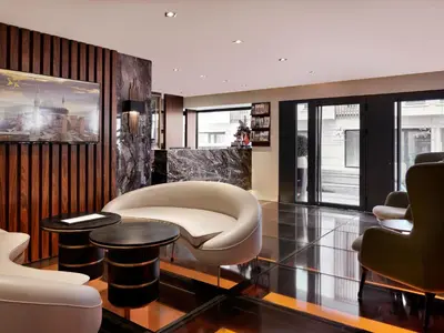 a living room with a white chair and tables at Shining Star Hotel in Istanbul