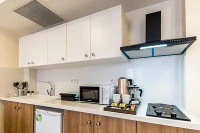 a kitchen with white cabinets and a stove top oven at Monnas Suite in Istanbul