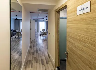 an open door to an office with a hallway with chairs at Monnas Suite in Istanbul