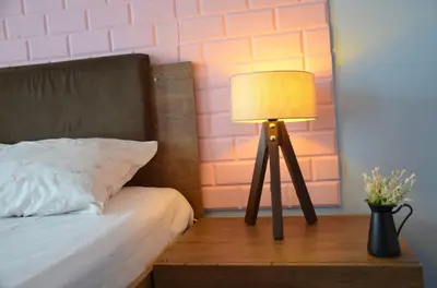 a lamp sitting on a table next to a bed at Retro Suites in Istanbul